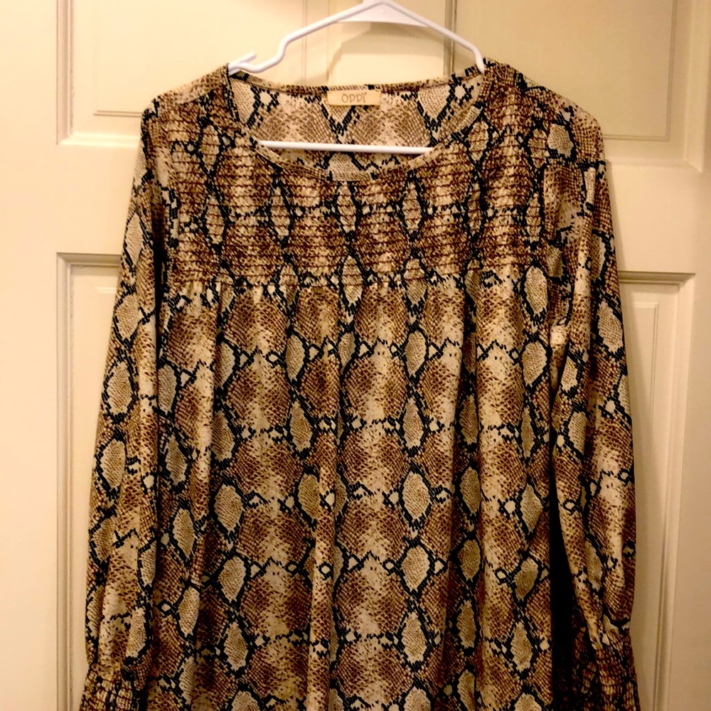 Printed blouse with smocking at wrist and across the front at neckline.